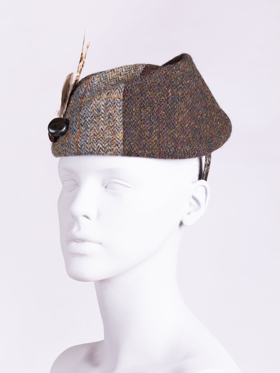 handwoven tweed hat with feathers and leather buttons
